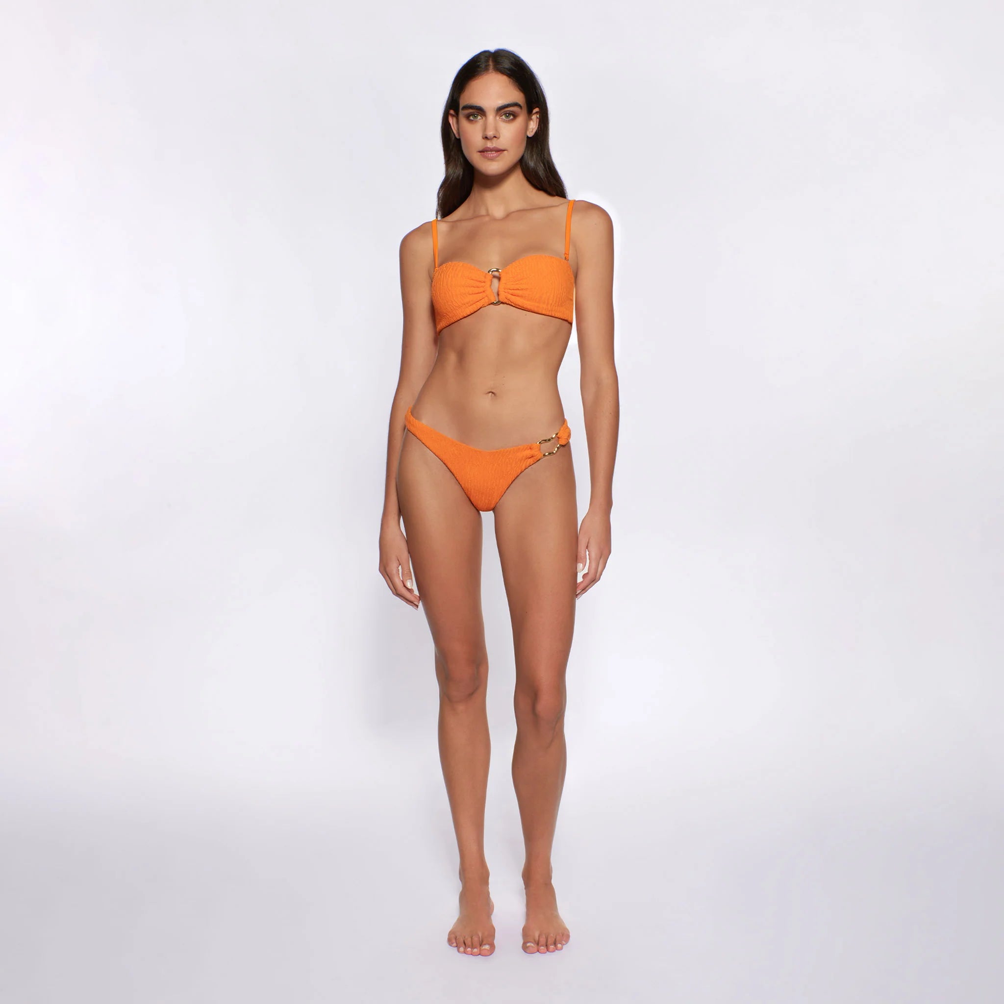 Textured bandeau with gold hardware in the front and removable straps in orange