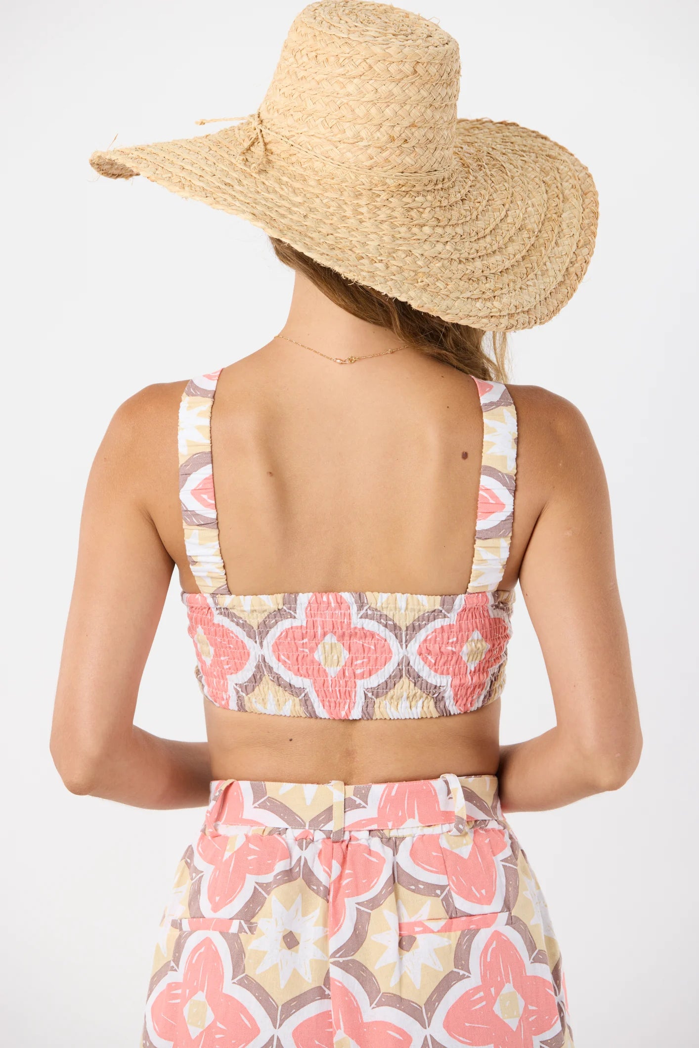 Cropped bandeau style top with ring front in tile print