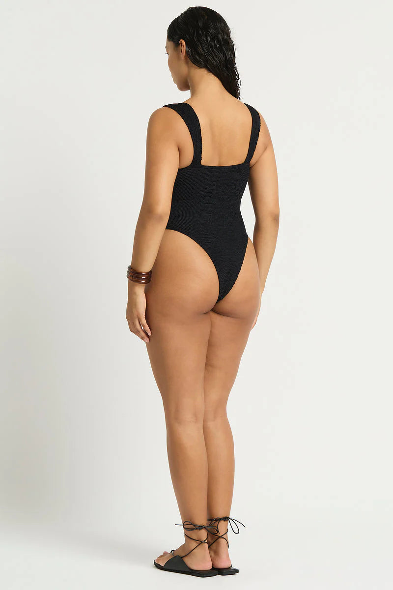 Black one size one piece with front cutouts, ring details, and minimal coverage in the back