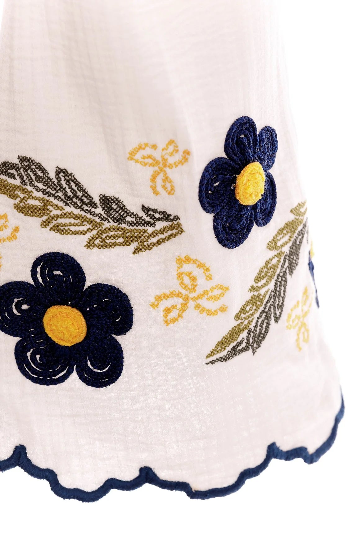 White top with long bell sleeves and blue and yellow floral embroidery