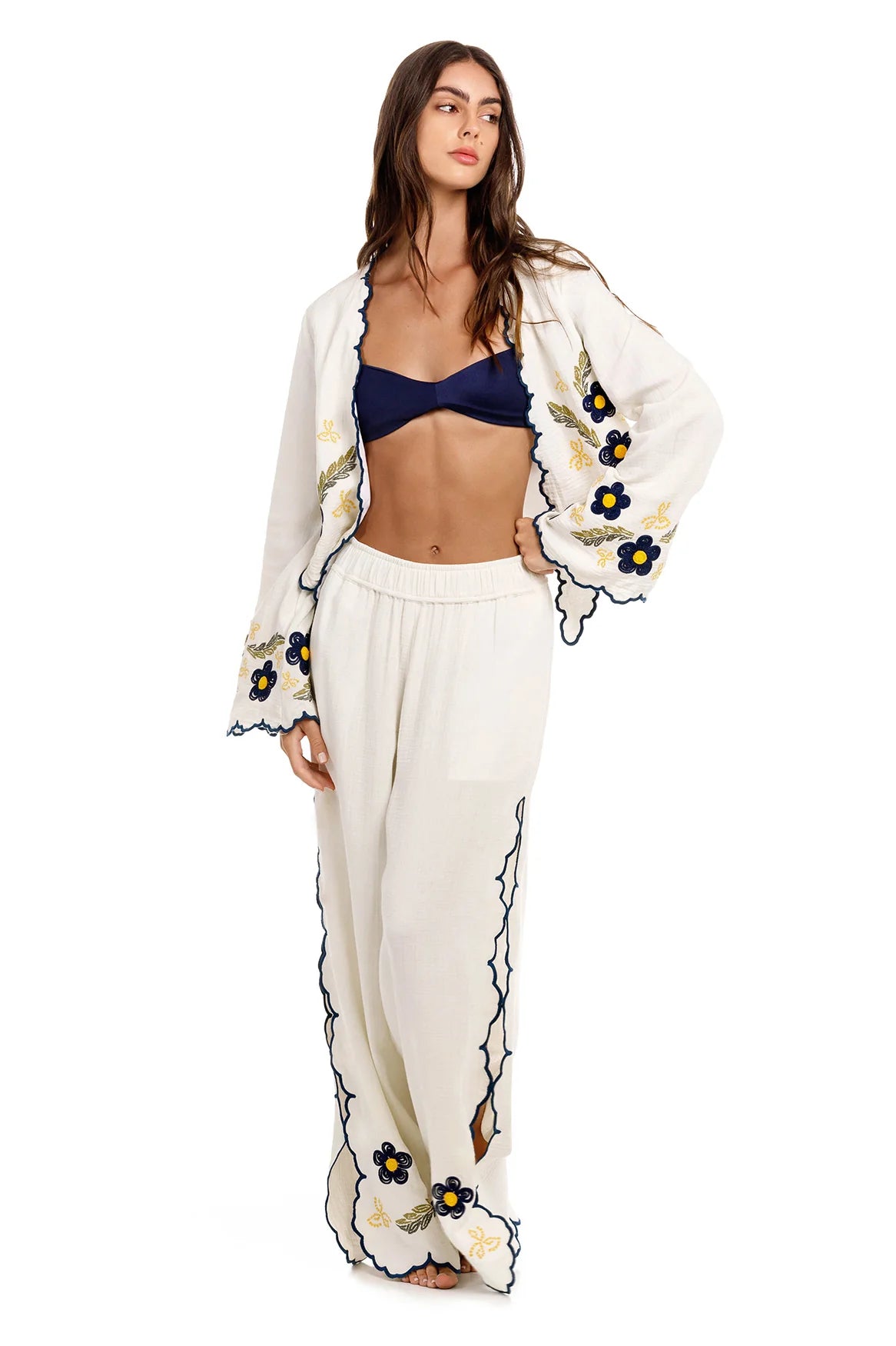 White wide leg pants with elastic waistband and blue and yellow embroidered floral print