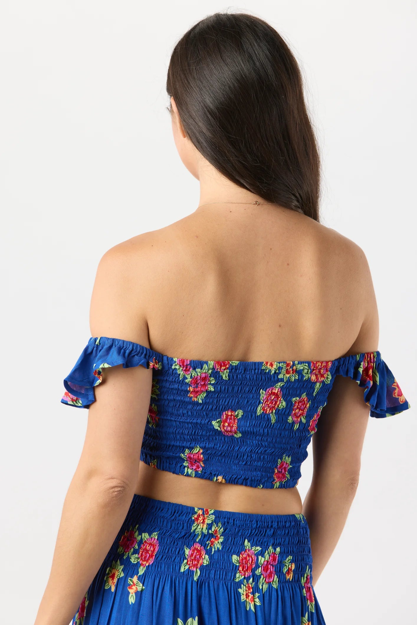 Smocked crop top with ruffled sleeves in blue with floral print
