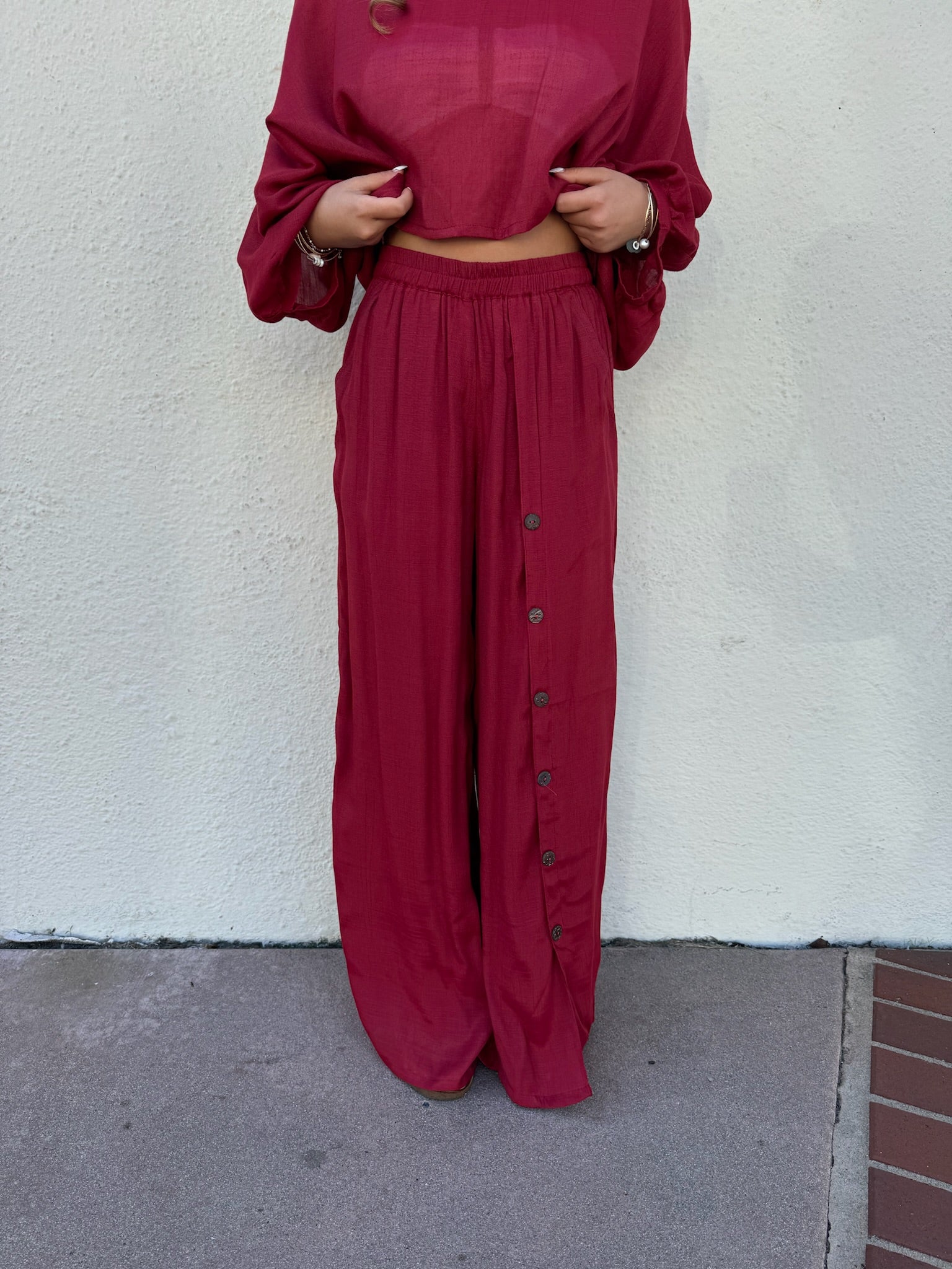 Flowy red pants with buttons down the left side