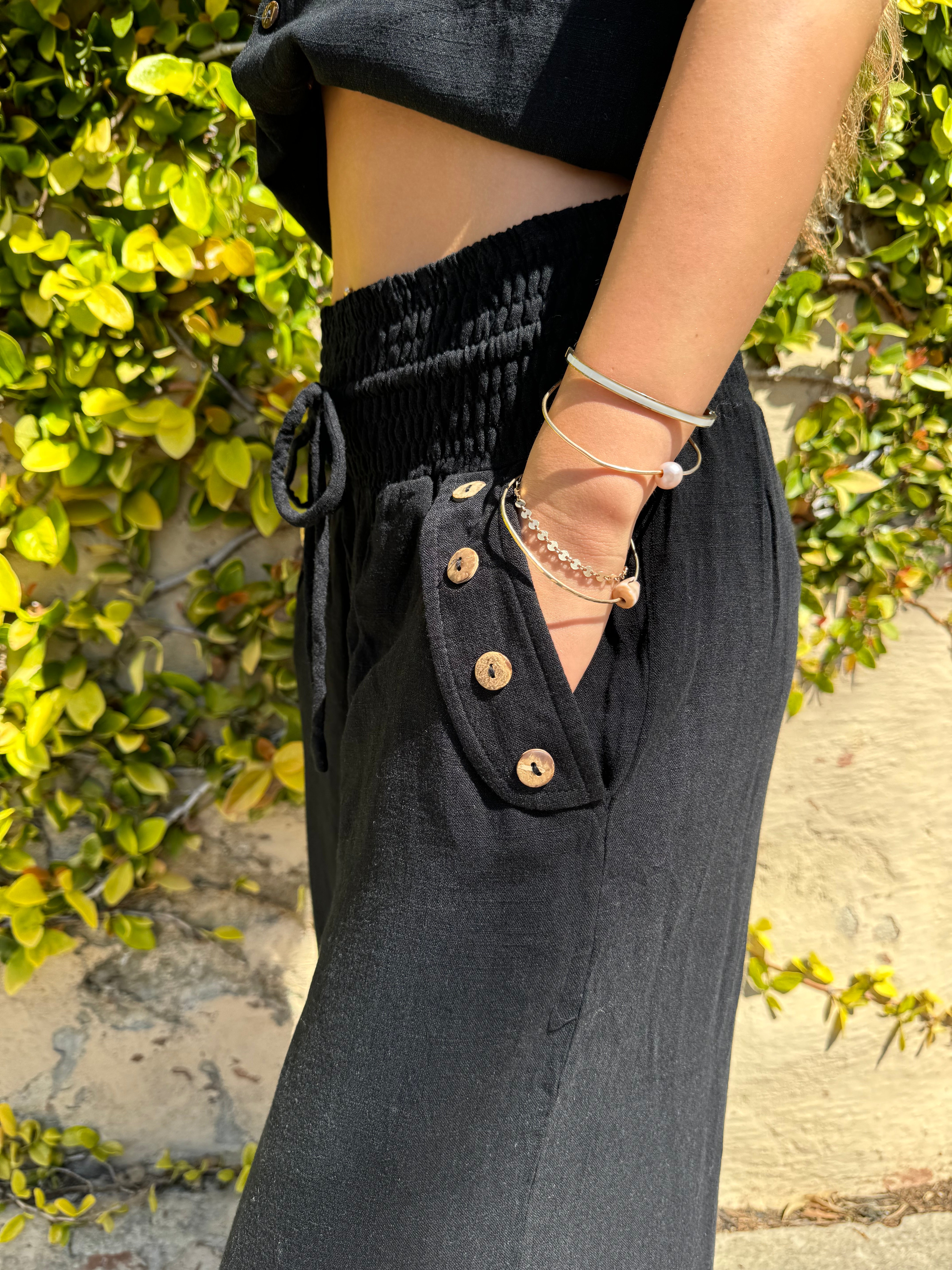 Bamboo pants with decorative buttons down each side in Black.