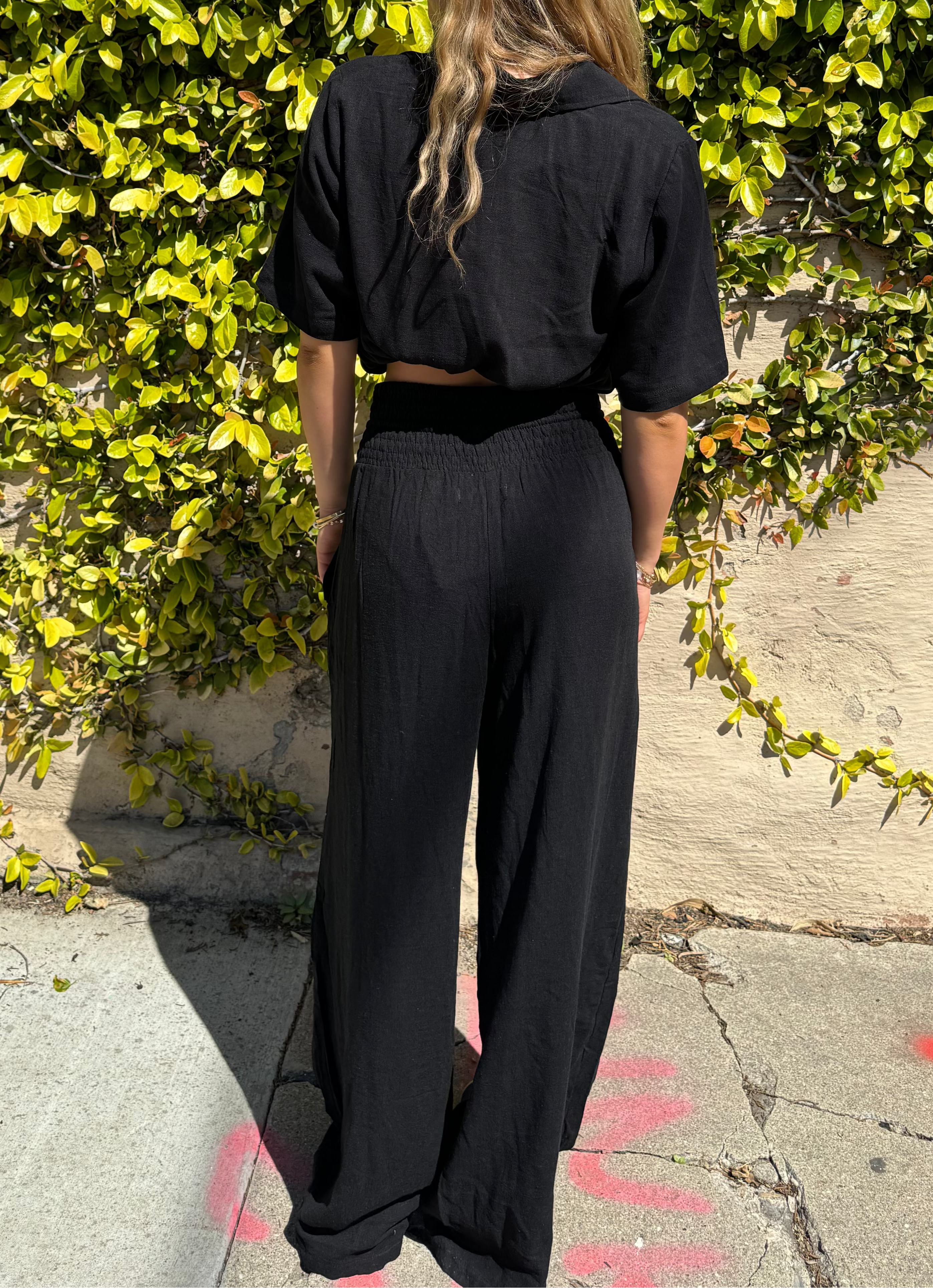 Bamboo pants with decorative buttons down each side in Black.