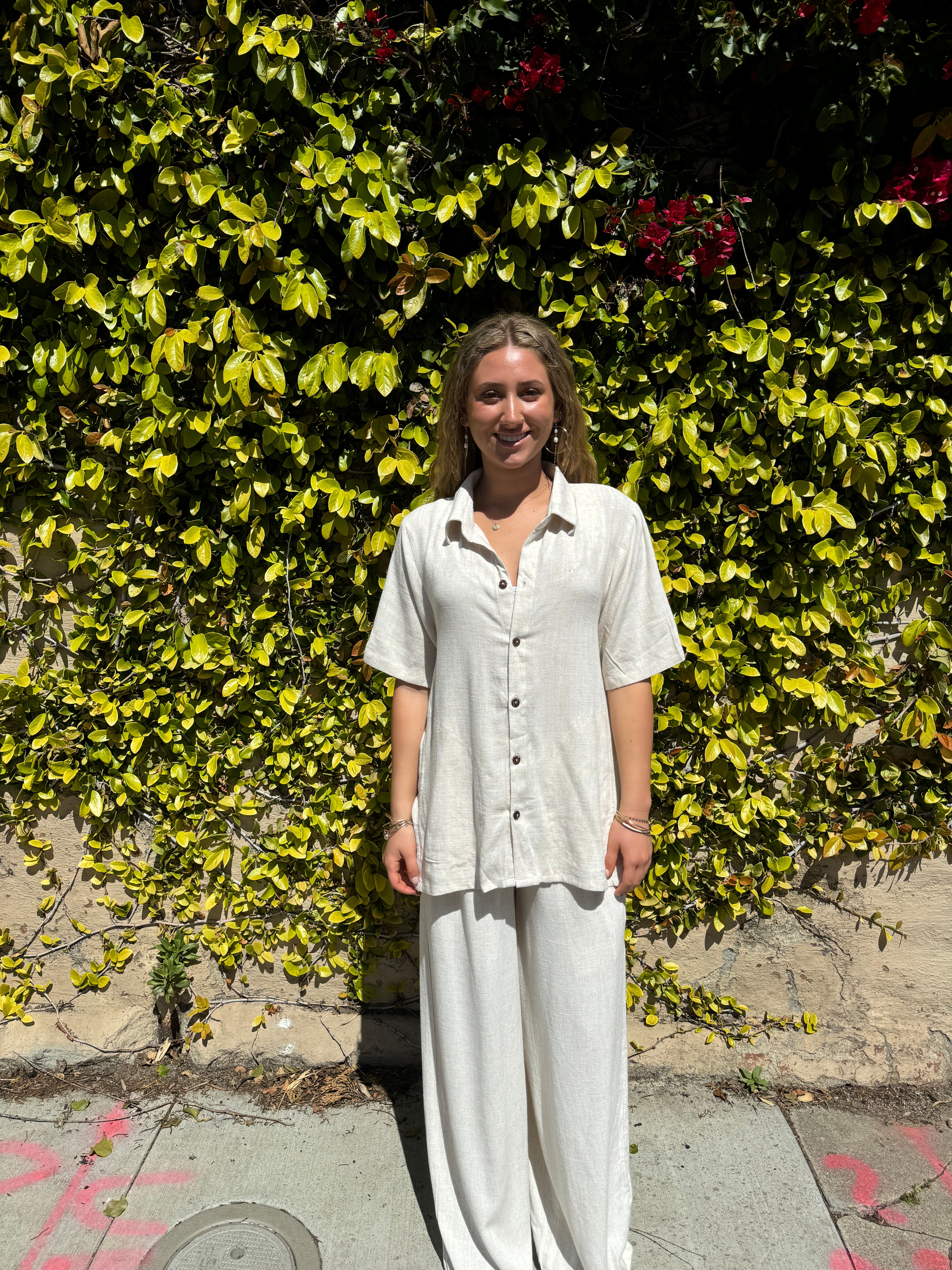 Bamboo pants with decorative buttons down each side in Cream.