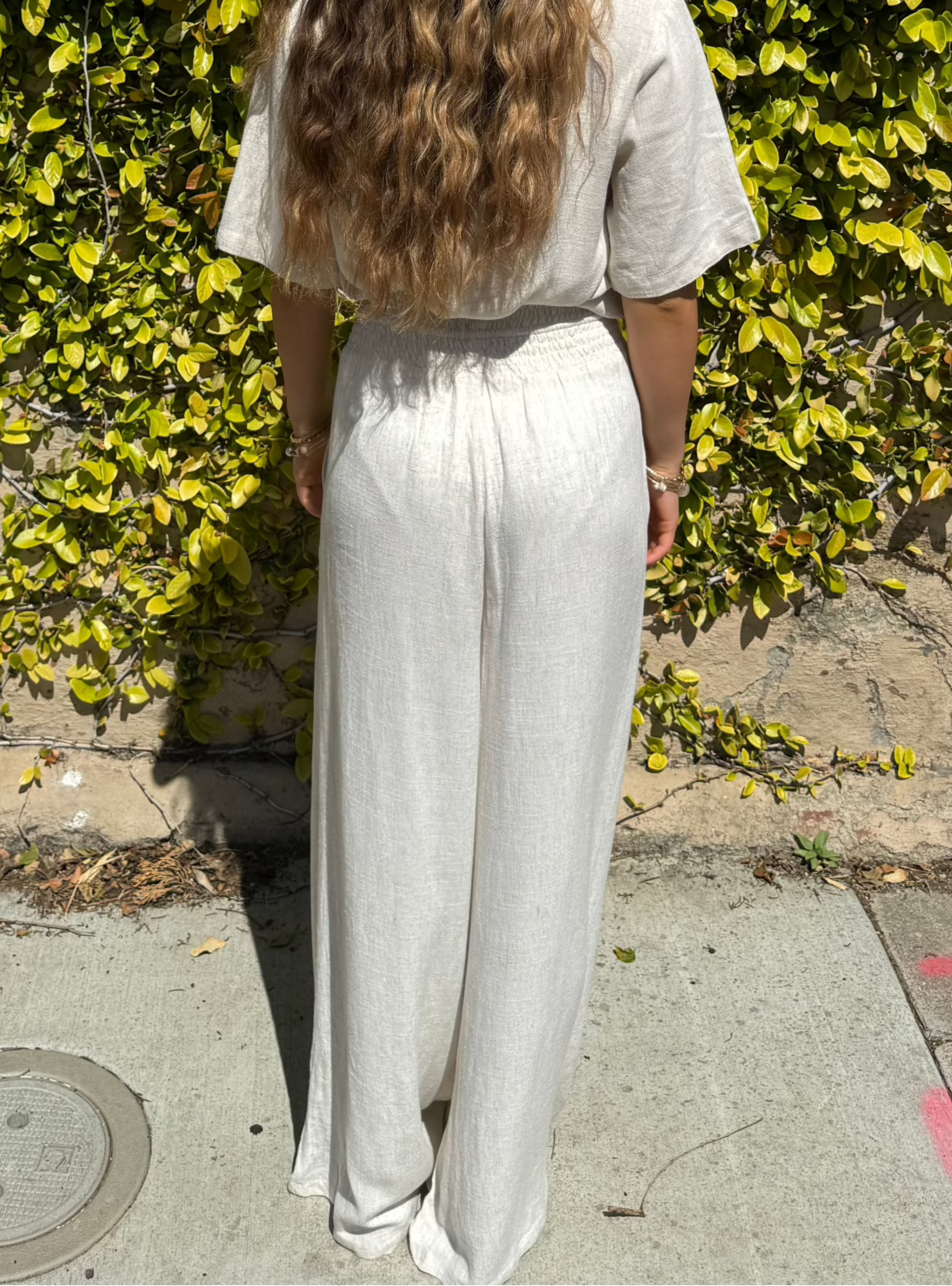 Bamboo pants with decorative buttons down each side in Cream.