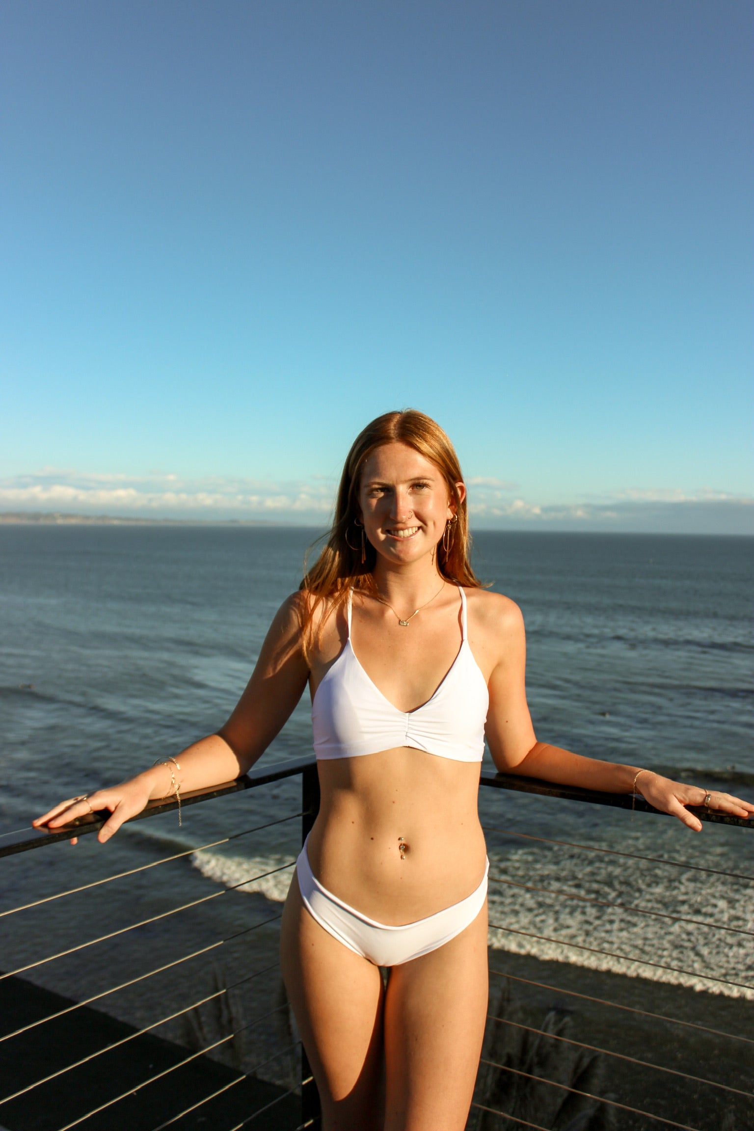 Ruched front top with criss cross strings and a tie in the back. Available in White