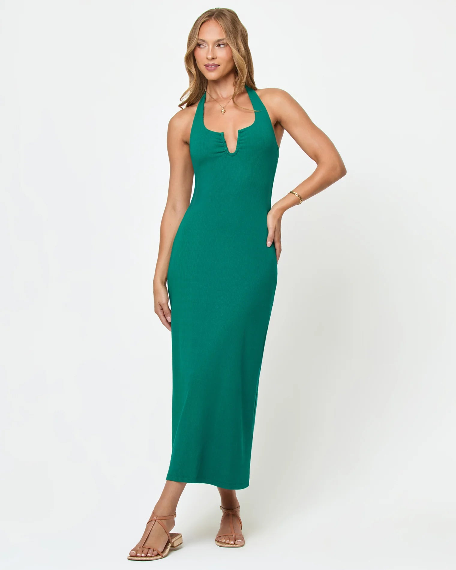 Green body hugging midi dress with a halter neckline and u bar front