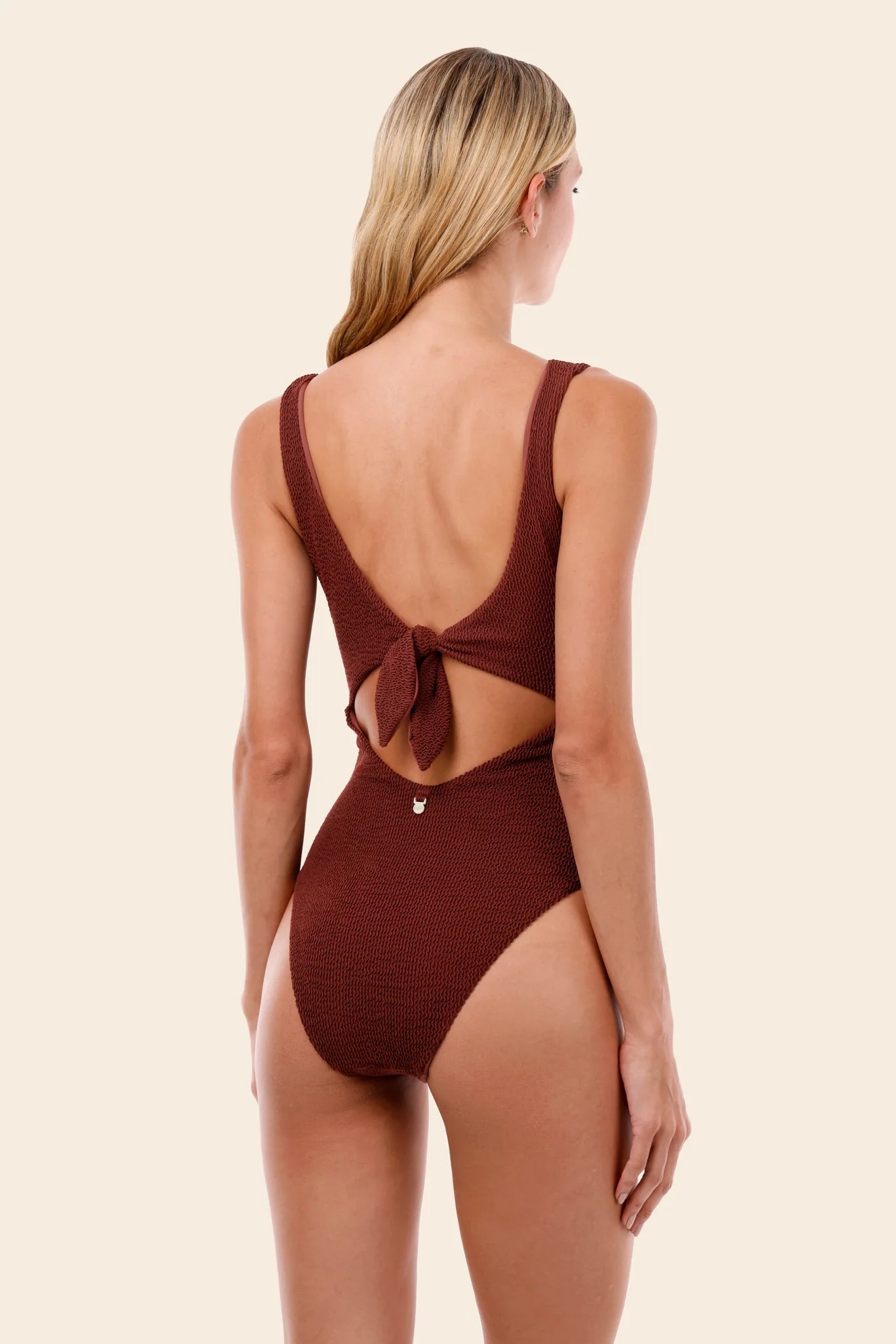 Textured one piece with front and back cutouts and a tie back