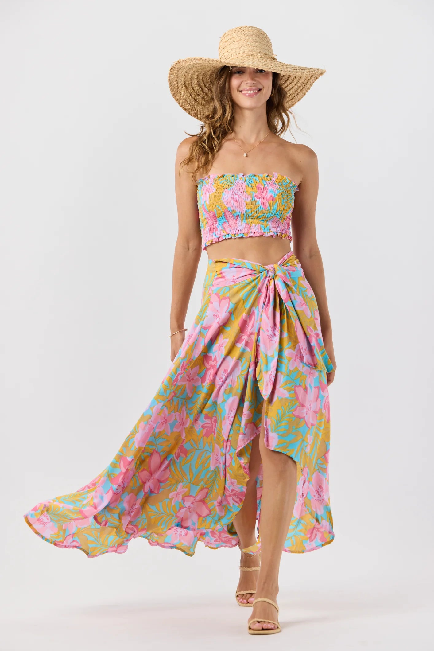 Smocked sleeveless crop top with ruffled edges in a colorful floral print