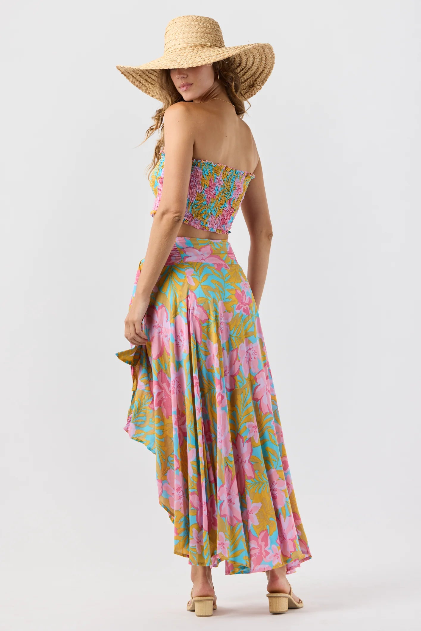 Smocked sleeveless crop top with ruffled edges in a colorful floral print