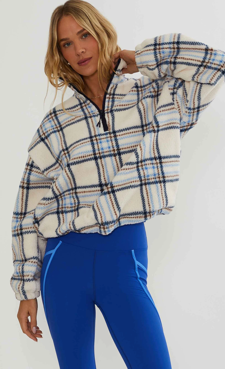 Faux fur pullover sherpa with a quarter zip neckline in plaid
