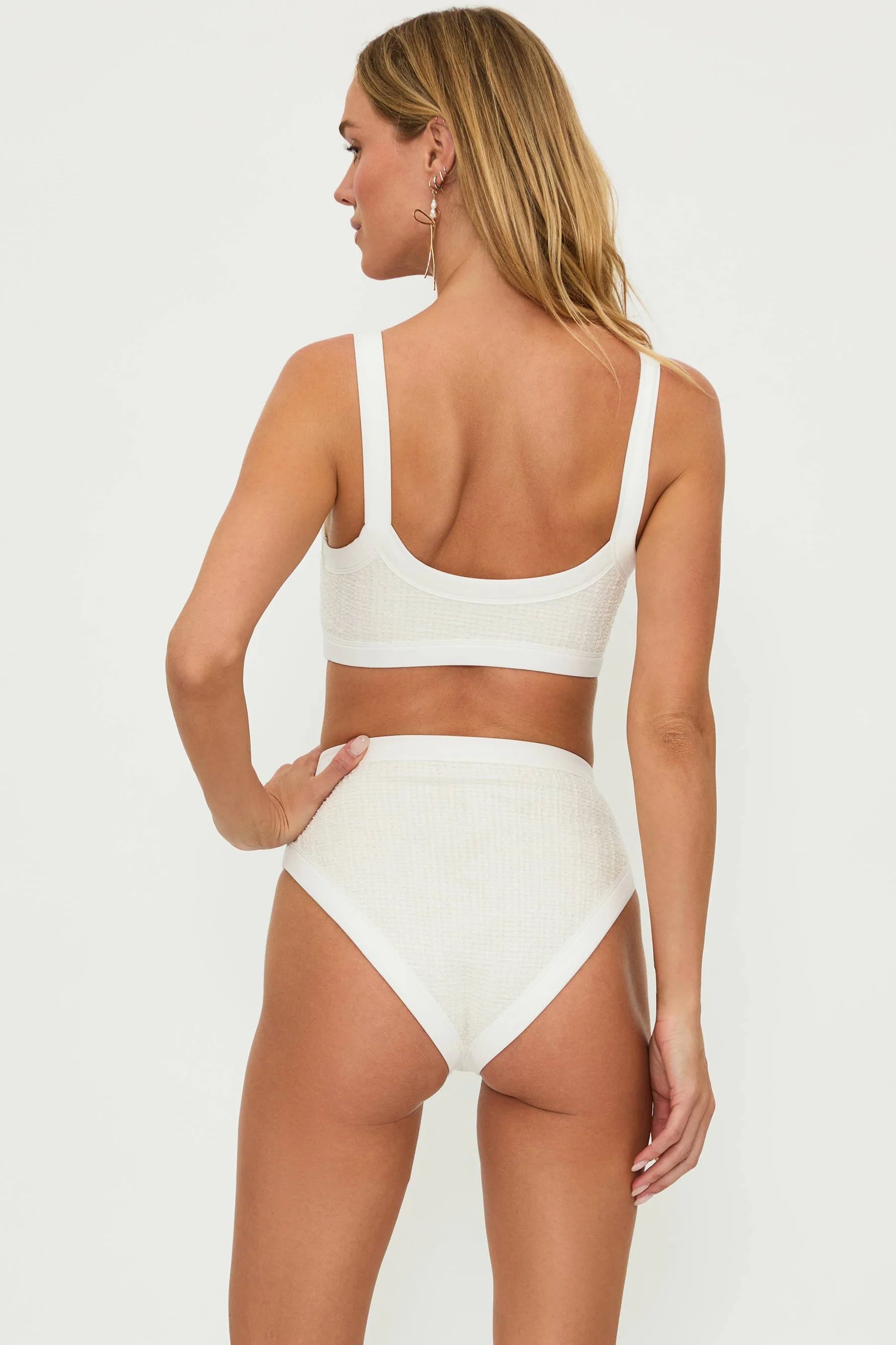 Textured ivory bottom with decorative gold buttons and a high waist fit.