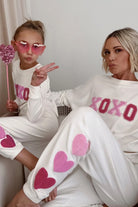 Sweatpants with hearts down the left side in cream
