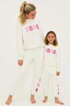 Sweatpants with hearts down the left side in cream