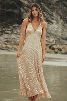 Maxi dress with tasseled halter ties and a plunging neckline