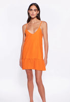 Short tiered dress with adjustable straps and ties in the back in orange