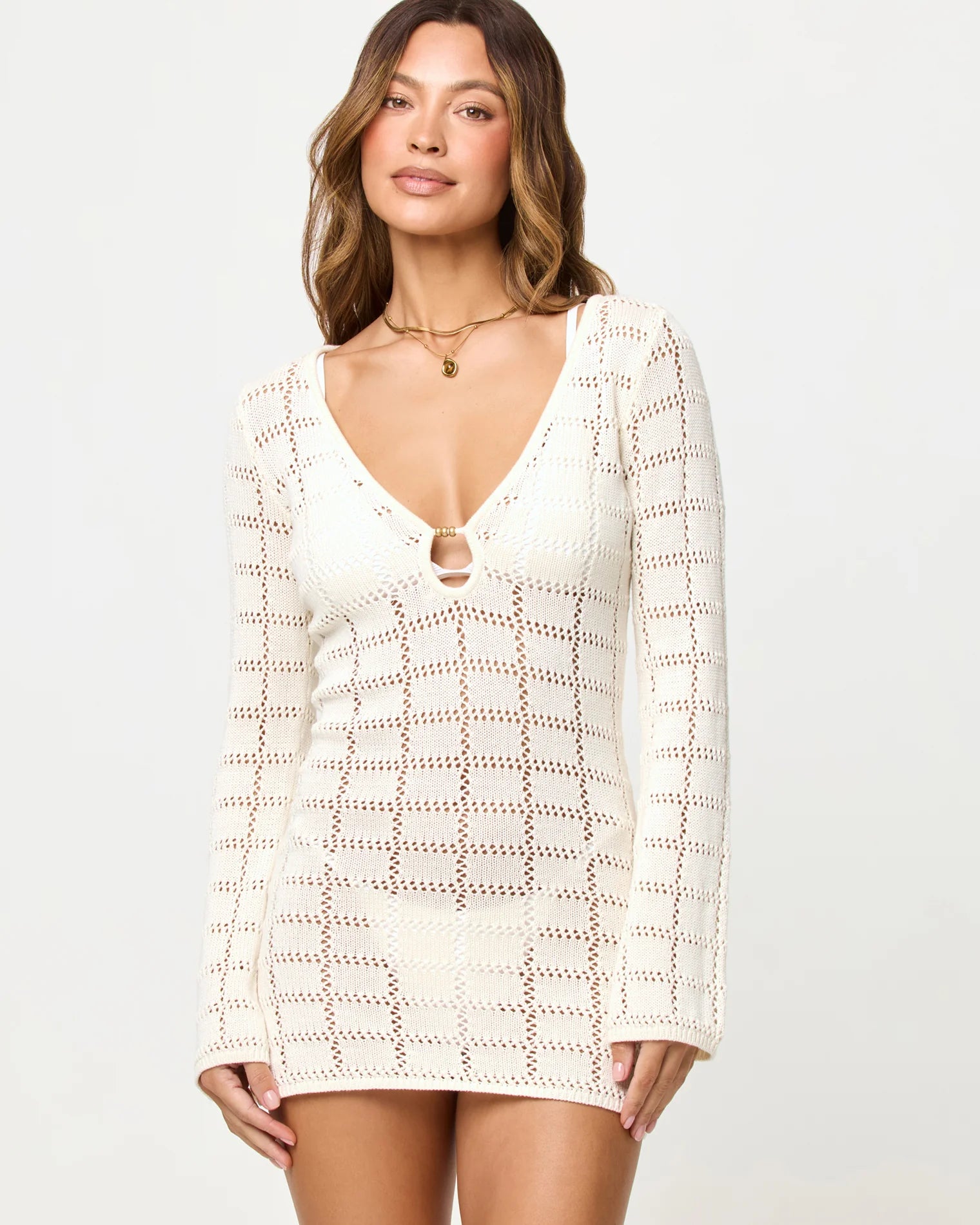 Open knit cotton mini dress with long sleeves and a plunging neckline