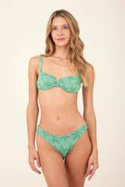 Underwire top with adjustable straps and a tie bak in green with palm tree print