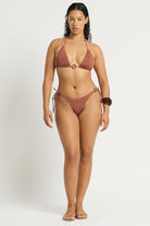 Shimmery brown triangle top with decorative ring in the front