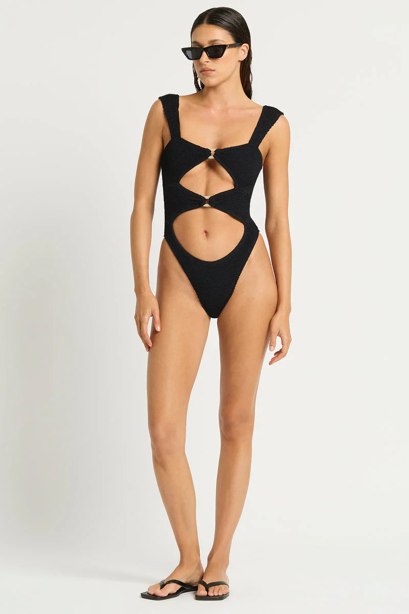 Black one size one piece with front cutouts, ring details, and minimal coverage in the back