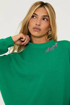 Green cotton sweatshirt with pink shamrock and lettering