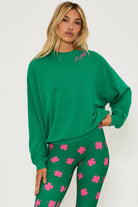 Green cotton sweatshirt with pink shamrock and lettering