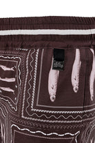 Boys swim trunks in brown wih white print