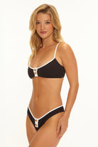 Skimpy bikini bottom with shell buttons in the front in black