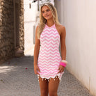 High neck knit mini dress with a halter tie and decorative beads and shells in pink and white.