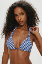 Adjustable triangle top with knotted halter ties  that reverses from gingham to star print
