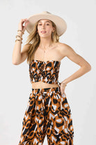 Strapless smocked crop top in brown and black print
