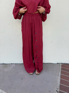 Flowy red pants with buttons down the left side