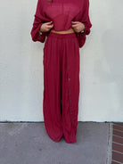 Flowy red pants with buttons down the left side