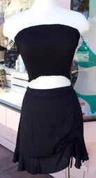 Short skirt in Black with a tie on the left front.