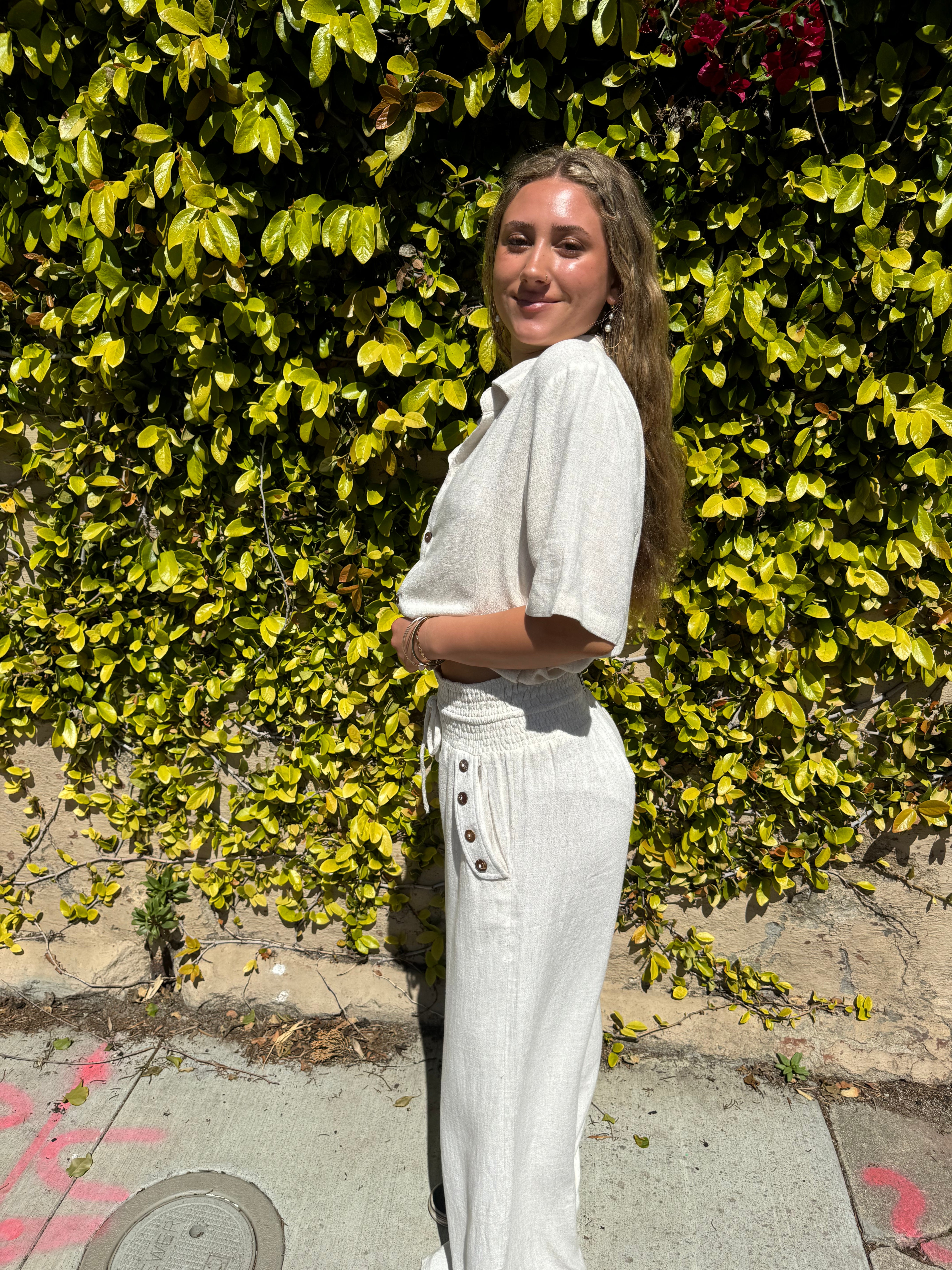 Bamboo pants with decorative buttons down each side in Cream.