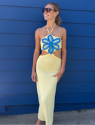 Yellow dress with a blue floral design and side cutouts