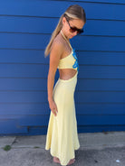 Yellow dress with a blue floral design and side cutouts