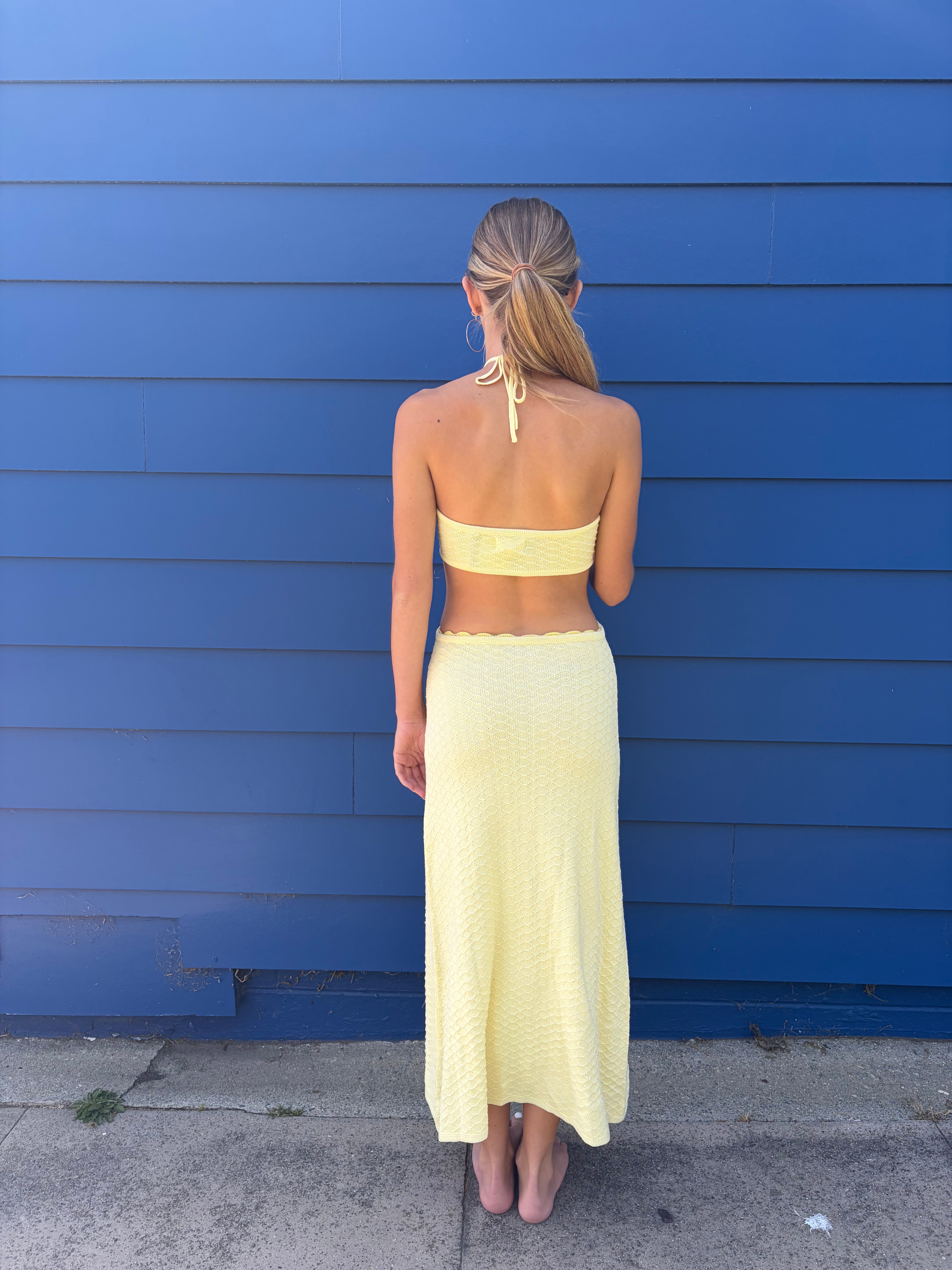 Yellow dress with a blue floral design and side cutouts