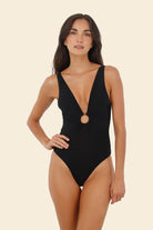 Black one piece with deep plunging neckline and decorative ring
