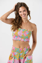 Smocked sleeveless crop top with ruffled edges in a colorful floral print