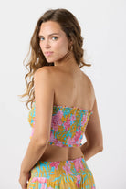 Smocked sleeveless crop top with ruffled edges in a colorful floral print