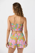 Smocked sleeveless crop top with ruffled edges in a colorful floral print