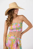 Smocked sleeveless crop top with ruffled edges in a colorful floral print