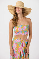 Smocked sleeveless crop top with ruffled edges in a colorful floral print