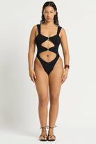 Black one size one piece with front cutouts, ring details, and minimal coverage in the back