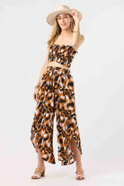 Strapless smocked crop top in brown and black print