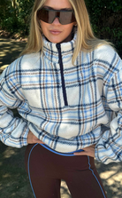 Faux fur pullover sherpa with a quarter zip neckline in plaid