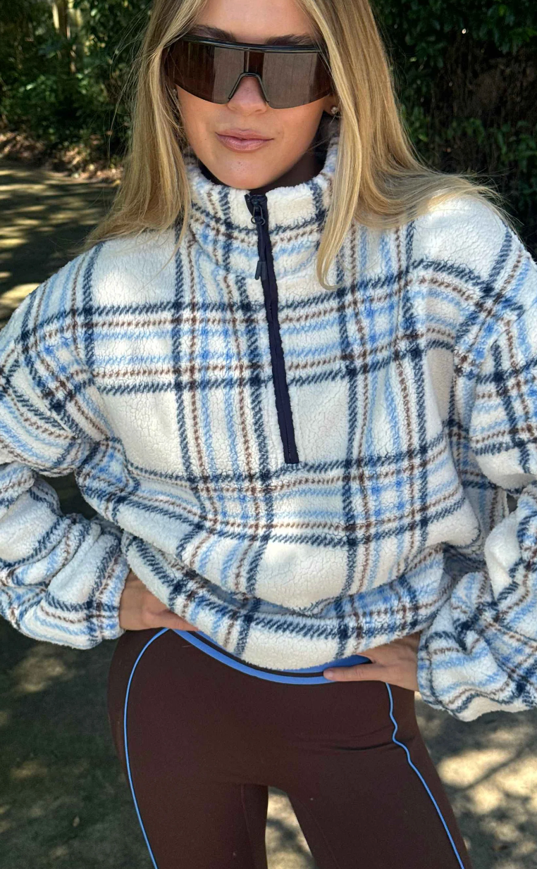 Faux fur pullover sherpa with a quarter zip neckline in plaid